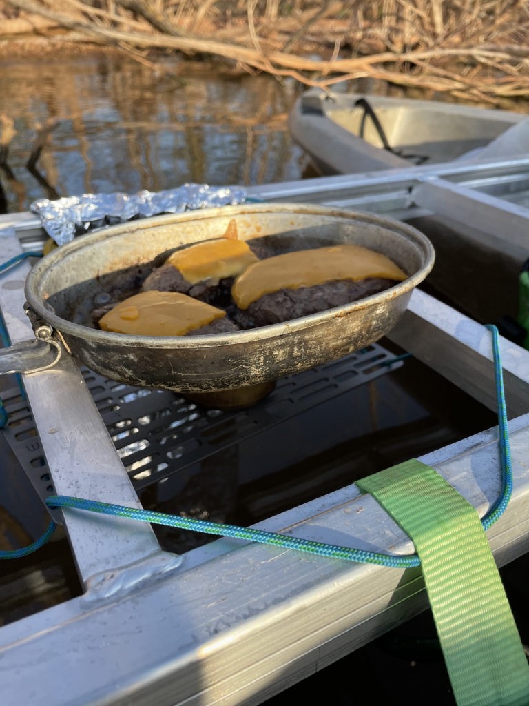 Cooking burgers on a 12ft Kayakamaran with floating alcohol stove