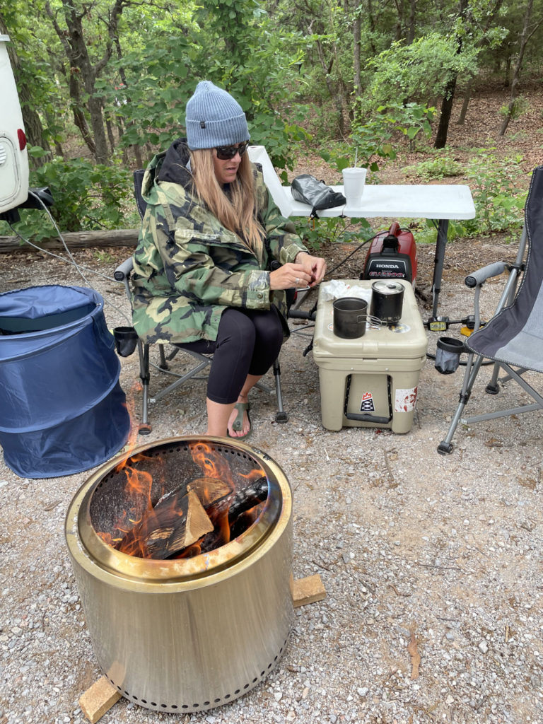 Corrie eating crawfish on Yeti next to SoloStove