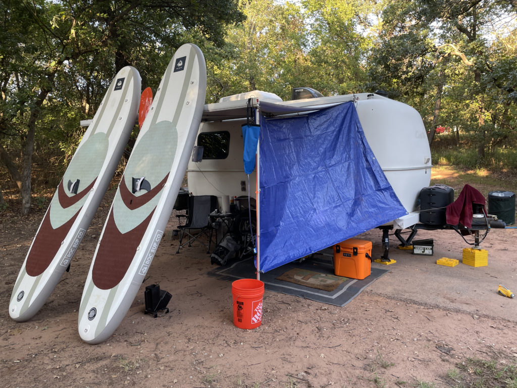 Using a tarp and blow up paddle boards to help shade the Casita porch.