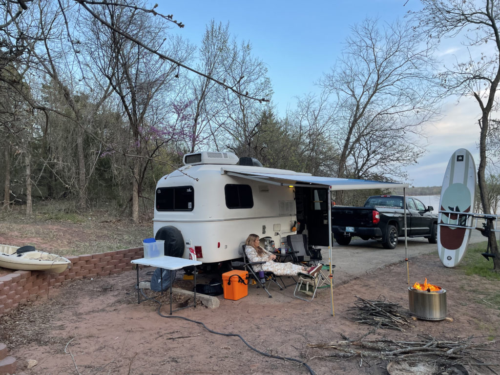 A shot of camp with a little bit of lake in the background.
