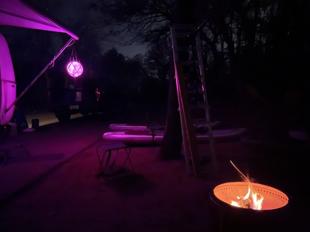 Casita at night with Solo Stove and purple hue.
